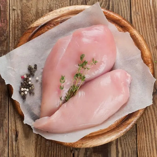 chicken breasts on wooden table