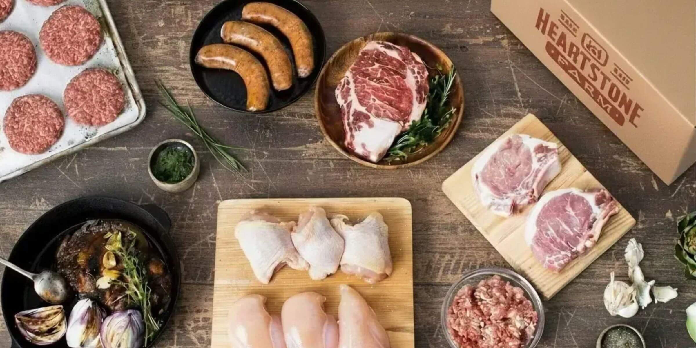 array of farm meat on wood table