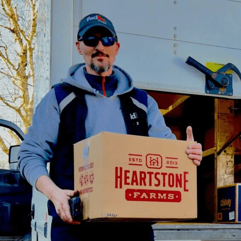 fedex delivery driver handing off heartstone farm meat box 