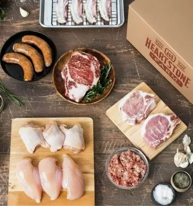 humane farm meat arranged on wood table